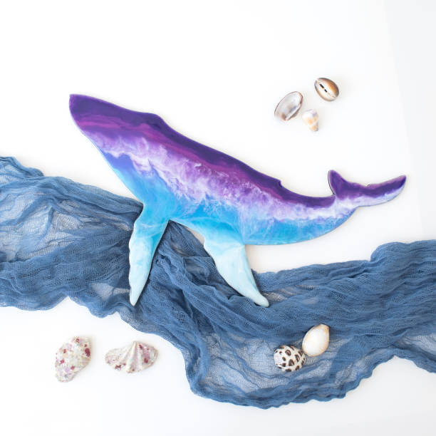 istock Resin art whale with fabric waves on white background. Flat lay, top view 1247634816