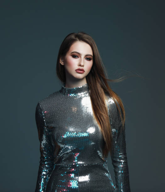 istock Beautiful young woman in sequin jumpsuit 1247637893