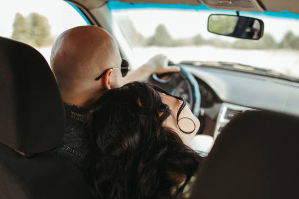 istock Young joyful couple traveling by car 1247643290