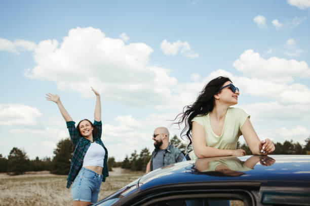 istock Three friends enjoying vacation travel by car 1247643298