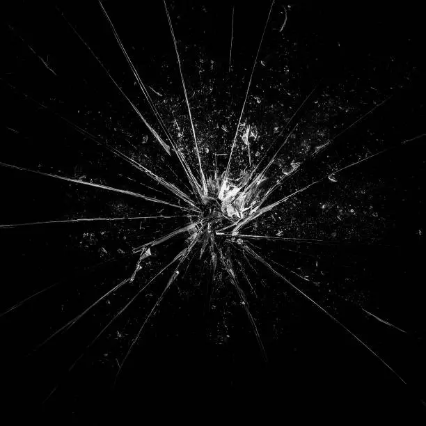 Broken glass background in black. Black minimalist background with cracks on the glass with water droplets. Abstract black minimalism.