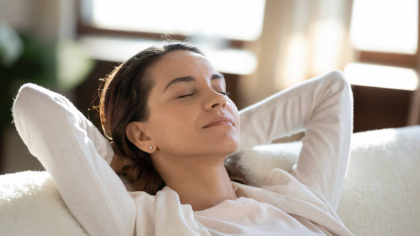 istock Calm young woman relax on couch dreaming 1247647713