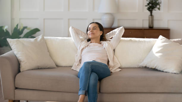 istock Happy young woman relax on couch dreaming or thinking 1247647715