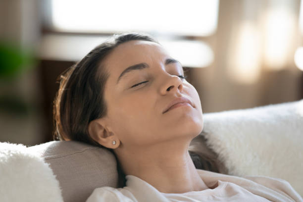 istock Calm young woman sleeping relaxing on sofa 1247647721