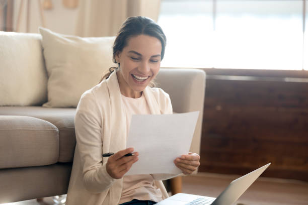 istock Happy young woman excited with good postal letter 1247647729