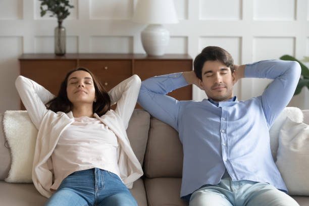 istock Millennial couple rest on sofa at home sleeping 1247647782