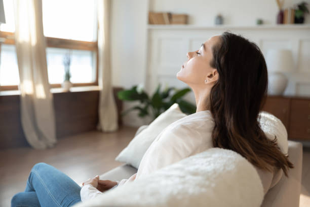 istock Calm young woman relax on sofa breathing fresh air 1247647786