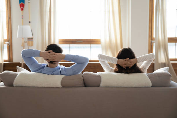 istock Back view of couple relax on design couch at home 1247647790