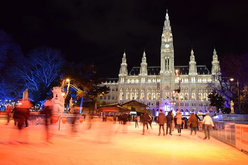 Ice Skating in front of Vienna City Hall (Christmas Time/ Holiday Celebrations) at Night in Wintry December - Vienna, Austria