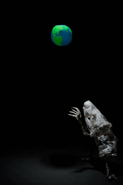 istock Plasticine Earth planet handmade above fantasy creature sculpture from plastic cups, forks and spoons, in selective light. Ecology Concept for Earth Hour, Earth Day, Ocean Day and other ECO dates. 1247652601