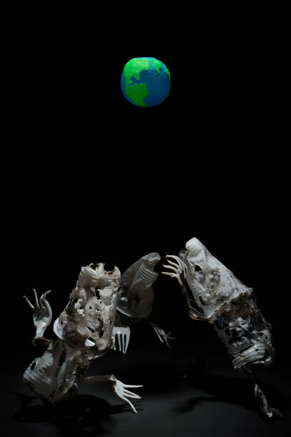 istock Plasticine Earth planet handmade above fantasy creatures sculpture from plastic cups, forks and spoons, in selective light. Ecology Concept for Earth Hour, Earth Day, Ocean Day and other ECO dates. 1247652702