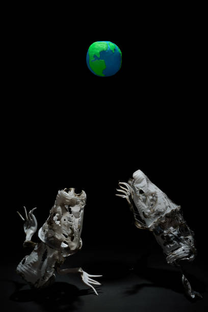 istock Plasticine Earth planet handmade above fantasy creatures sculpture from plastic cups, forks and spoons, in selective light. Ecology Concept for Earth Hour, Earth Day, Ocean Day and other ECO dates. 1247652742