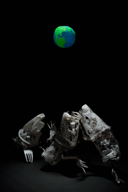 istock Plasticine Earth planet handmade above fantasy creatures sculpture from plastic cups, forks and spoons, in selective light. Ecology Concept for Earth Hour, Earth Day, Ocean Day and other ECO dates. 1247652835