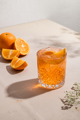 Summer fresh non-alcoholic cocktail with orange, ice and sparkling water. Mocktail, healthy life style. copy space