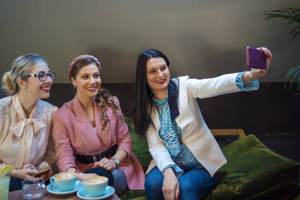 istock Women taking a selfie in a cafe 1247654715