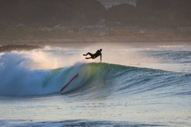 istock Man surfs waves on a beach near Tokyo just after a Typhoon has passed. 1247656358