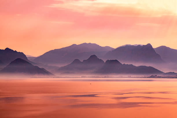 sahara dust in austria at lake woerth. orange sunrise in velden