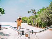 istock Pov point of view of couple cycling on tropical island 1247659910