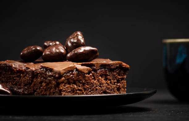 istock Delicious chocolate cake in dark plate on wooden table 1247663884
