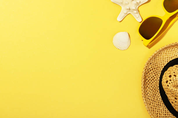 istock Straw hat, sunglasses, shell and starfish isolated on yellow background. Blank copy space in left side. Summer backdrop. Summer-time and travelling concept 1247665400