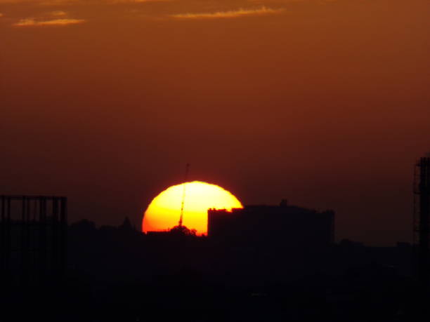istock Sun rising over London silhouette 1247665524