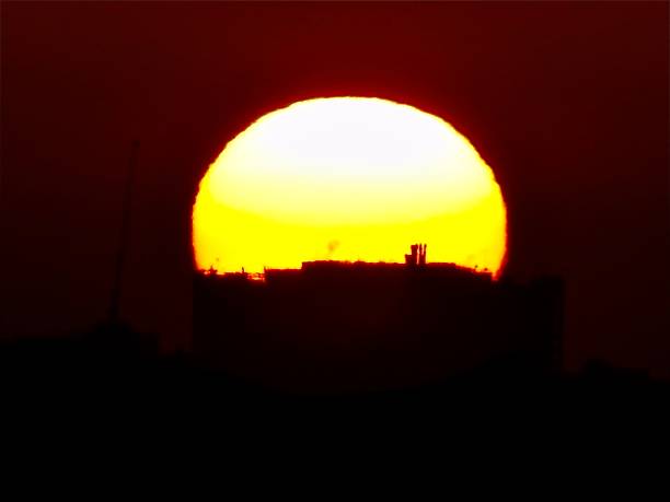 istock Sun rising over London silhouette 1247665603