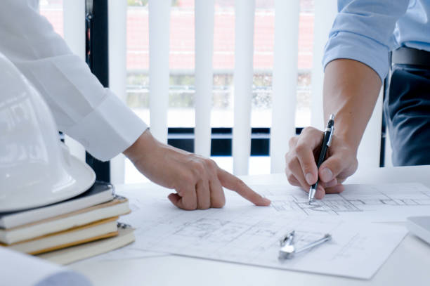 istock Colleagues interior designer Corporate Achievement Planning Design on blueprint Teamwork Concept with compasse. 1247667267