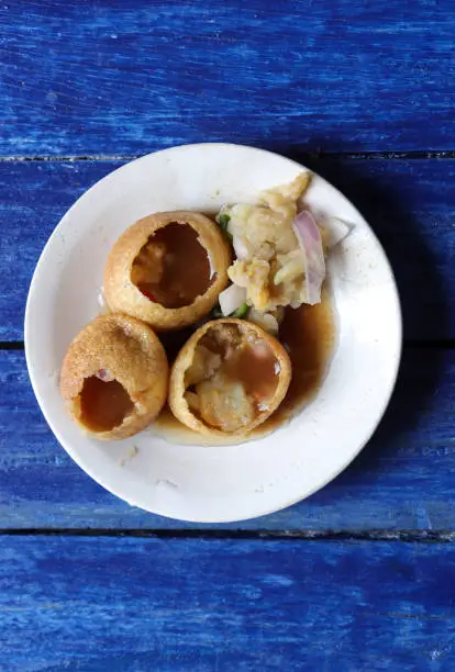 Golgappa or Panipuri is a very popular Indian Street Food. It has others names like Puchka, Pani Puri, Gol Gappe, Pakodi, Pani Patashi, Phuchka, Gup Chup etc. The round shape ball is called Puri and it is very soft, crisp and crunchy. It is served with Spicy or Masala Potato Paste, Tamarind Water or Chutney, Chickpea, Pea, Peanuts, Chilies, Onion and other things. It is very delicious and mouth watering food. It tastes sour and sweet. Golgappa or Panipuri shops or stalls are easily found in markets of India.