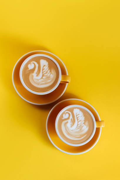 istock Coffee latte art on yellow background 1247673904
