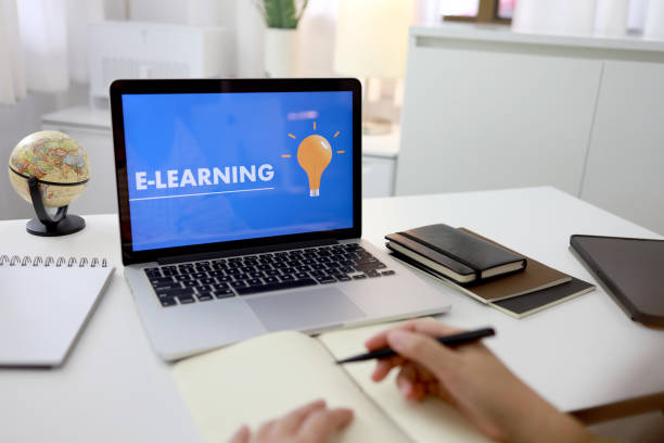 istock E-learning Education Internet Networking . Young businesswoman sitting at table used laptop with inscription on screen e-learning. Online education e-learning. 1247676846