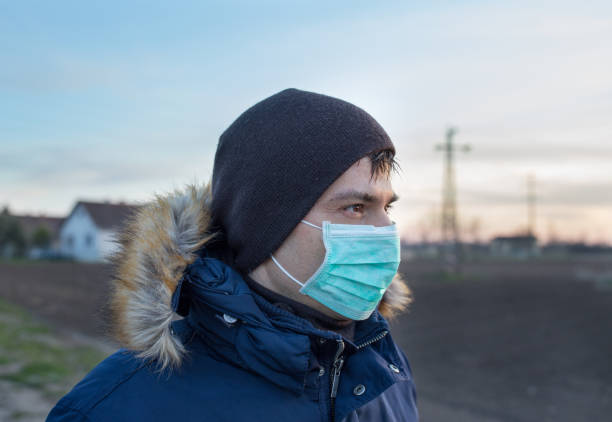 istock Man with safety face mask walking outdoor 1247678214