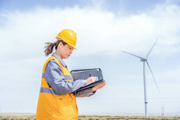 istock Asian female power engineer working at the wind power station 1247682145