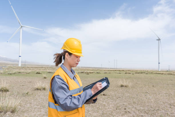 istock Asian female power engineer working at the wind power station 1247682298