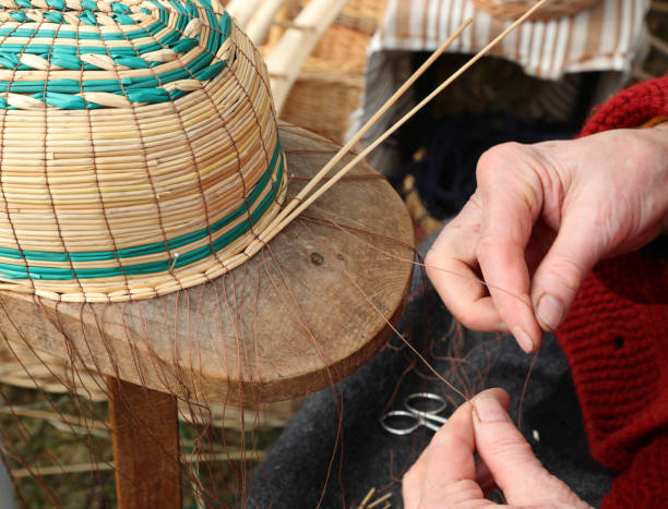 istock hands of an old craftswoman while creating a wicker basket 1247688082