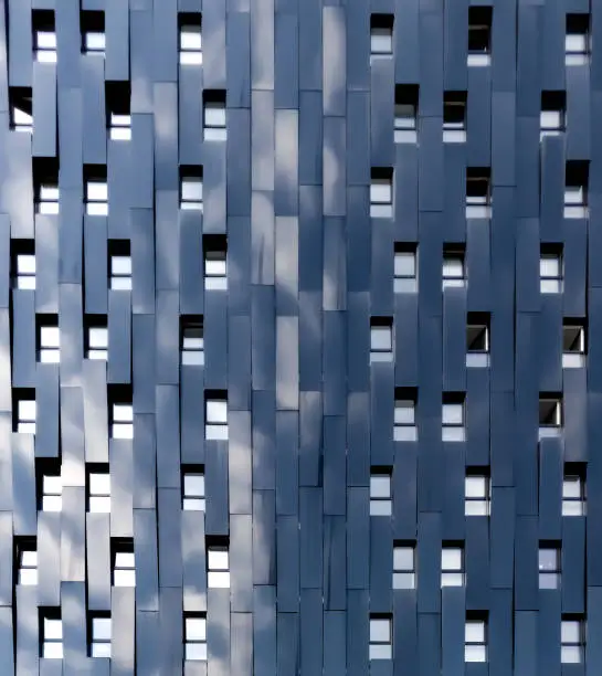 building facade made of black steel reflecting some clouds