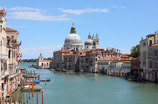 Exceptional typical view of the Island of Venice in Italy with the Grand Canal and the Dome of the Church called Madonna della Salute in Italy with few boats due to the lockdown caused by the Coronavirus