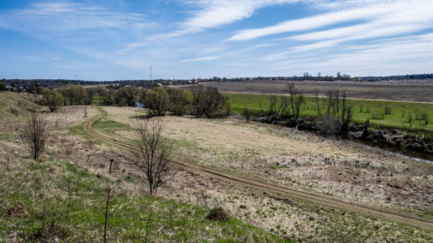 istock A winding road in the middle of a spring field 1247688927