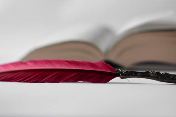istock an ancient open book and a red ink pen 1247696289