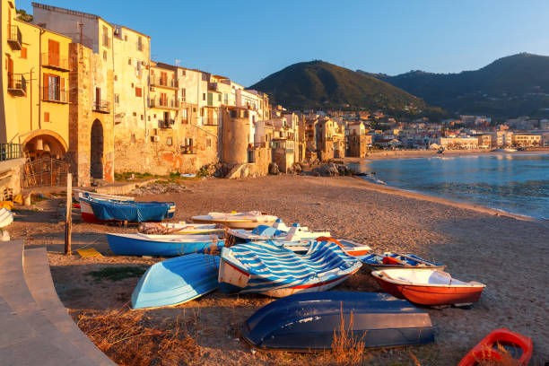 Cefalu at sunset, Sicily, Italy Boats on the beach and sunny houses in coastal city Cefalu at sunset, Sicily, Italy cefalu stock pictures, royalty-free photos & images