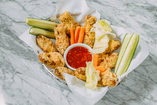 istock chicken nuggets with sauce and vegetables on a marble table 1247727776