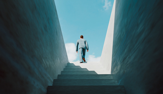 Concept of taking the right decisions and be moving in the right direction. Businessman walks on a staircase from a dark cellar to the top where he reaches sunshine and success.
Note: The man is a 3D-render with face scan. Model release attached.