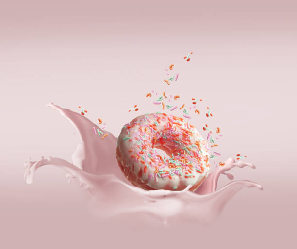 istock Donut dropped in cream with splash and flying particular 1247731071