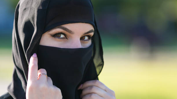 istock Arab woman in a black scarf on her head. 1247733355