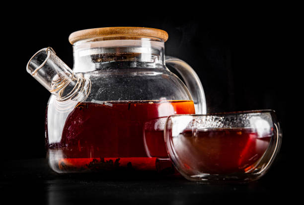 istock tea pot and Cup of puer tea on black background 1247733617