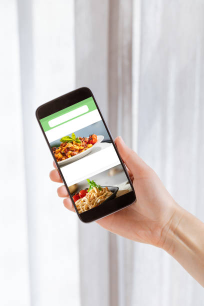 istock Mobile with white blank screen in woman hand on light background. Clipping path screen. 1247735384