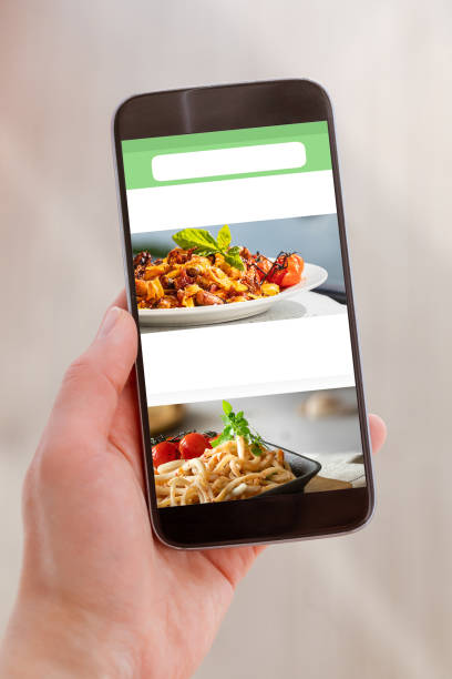 istock Mobile with white blank screen in woman hand on light background. Clipping path screen. 1247735406