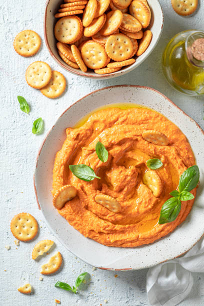 istock Yummy tomato hummus with crackers, oil and basil 1247735741