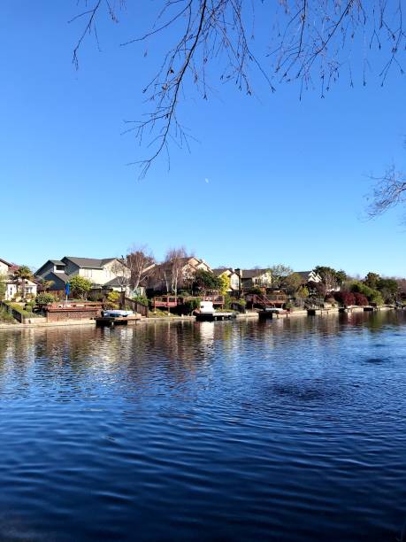 istock Reflection on the water houses near river 1247736047