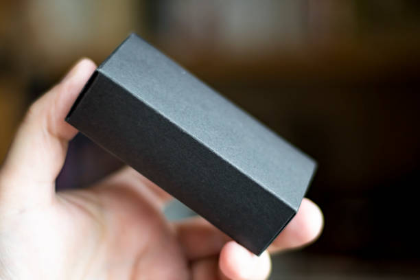 istock Closeup of a hand that holds a small black box 1247744087