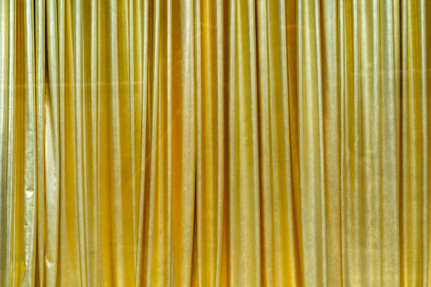 istock Folds of golden fabric. 1247746873